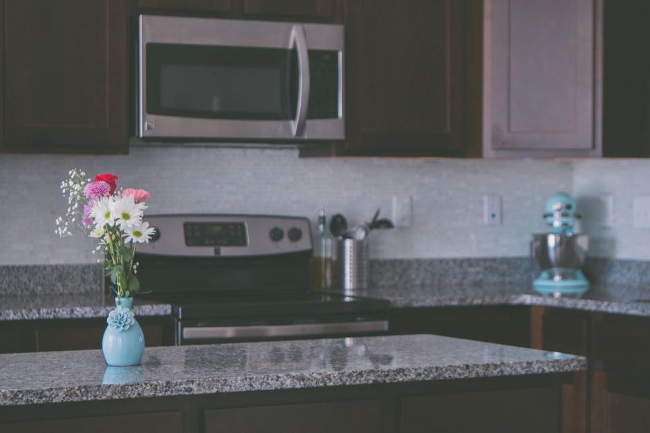A contemporary kitchen featuring granite countertops.
