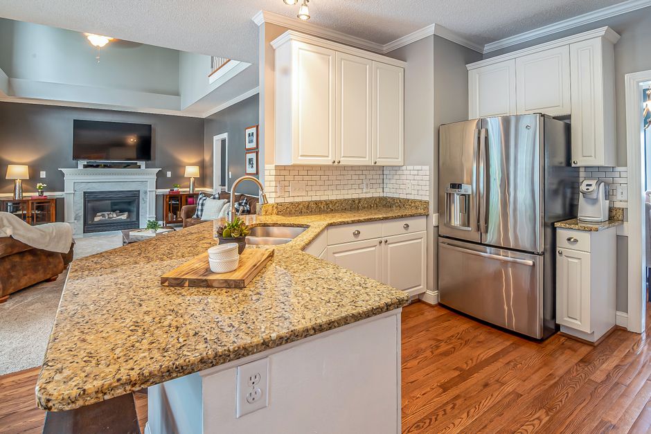 Luxurious open-concept kitchen with granite countertops and modern appliances.
